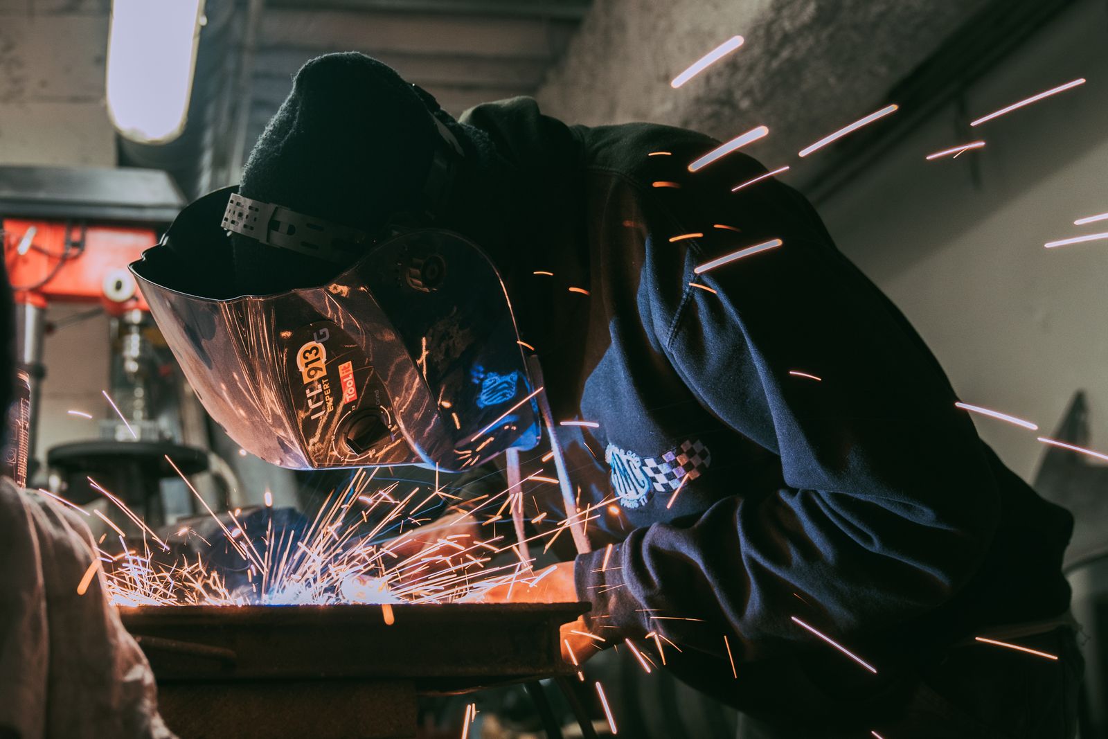 Welder working with sparks in a workshop